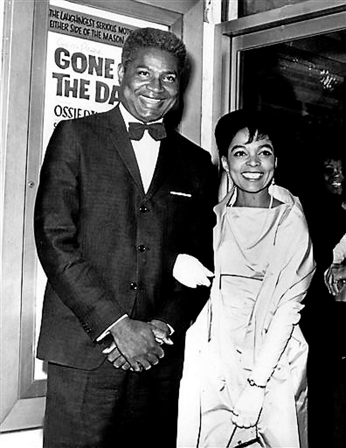 In this Sept. 23, 1963, file photo, actors Ossie Davis, left, and Ruby Dee pose in front of the movie poster at the opening night gala of their film “Gone Are the Days!” based on Davis’ play “Purlie Victorious,” at the Trans-Lux East Theater in New York City. Dee, an acclaimed actor and civil rights activist whose versatile career spanned stage, radio television and film, has died at age 91, according to her daughter. Nora Davis Day told The Associated Press on Thursday, June 11, 2014, that her mother died at home at New Rochelle, New York, on Wednesday night.