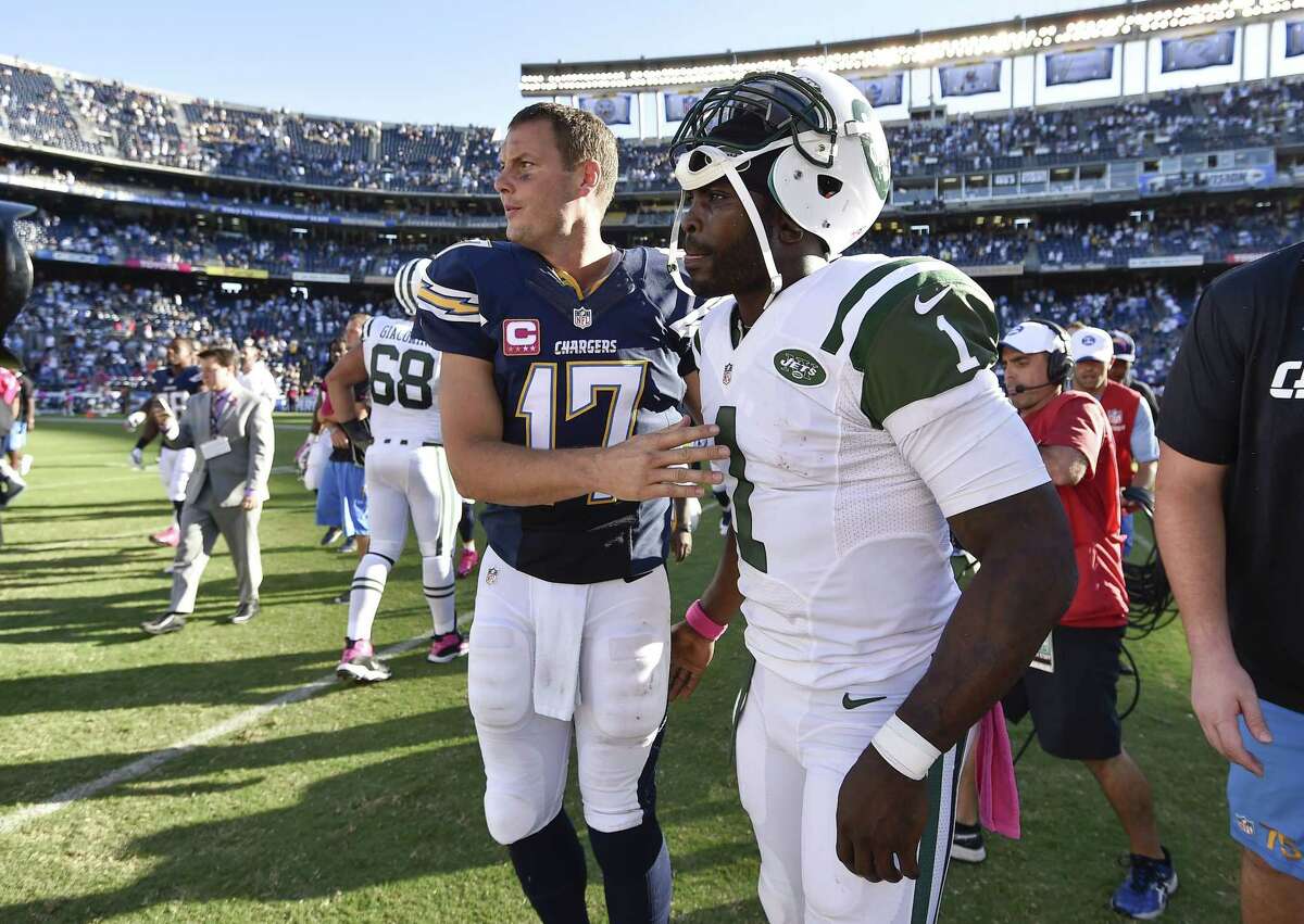 Chargers quarterback Philip Rivers, left, greets Jets quarterback Michael Vick after Sunday’s game.