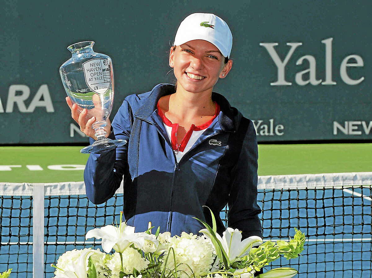 Simona Halep holds the trophy after her 6-2, 6-2, victory over Petra Kvitova in the 2013 final of the New Haven Open. The tournament will now be called the Connecticut Open presented by United Technologies.