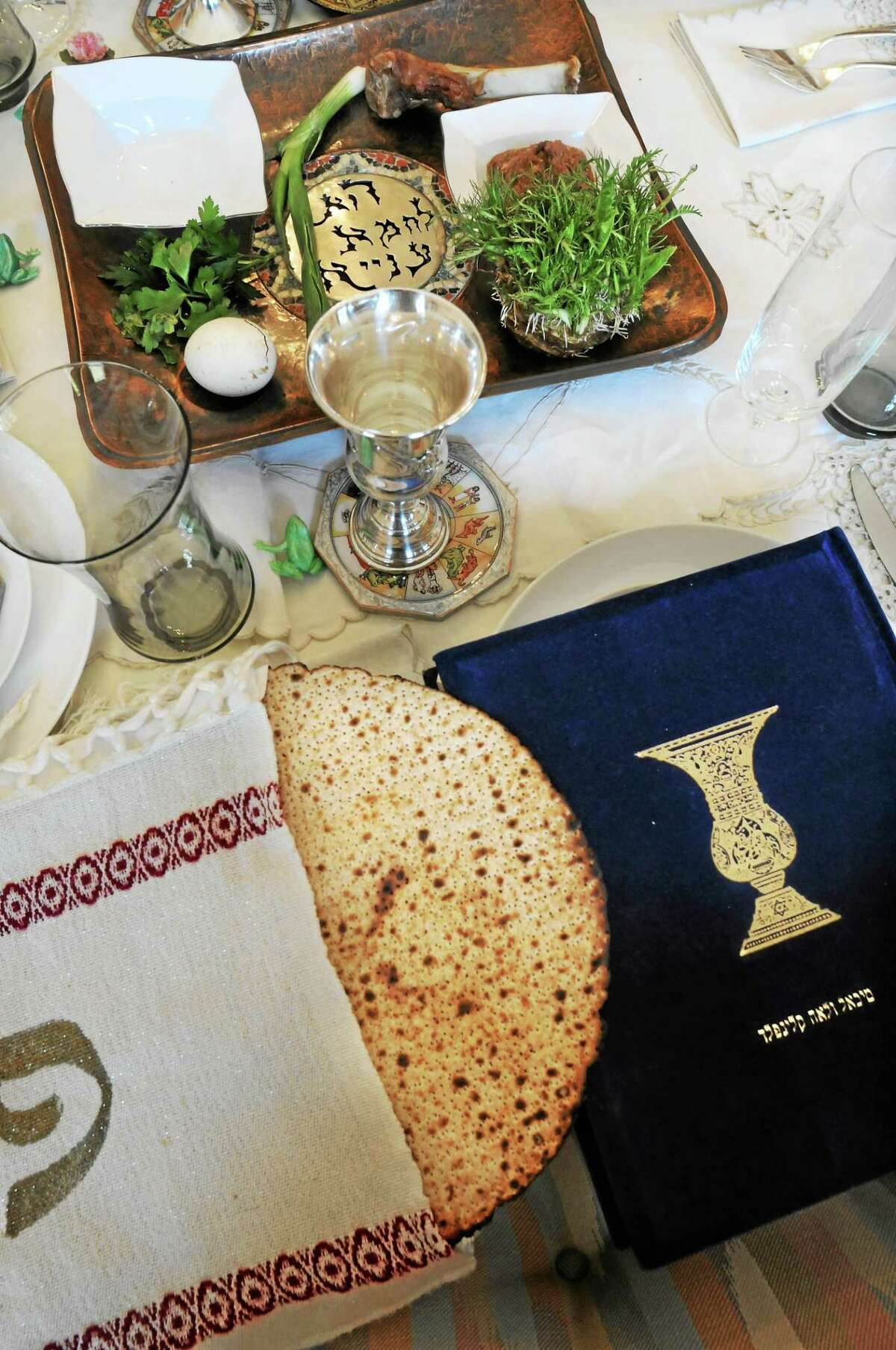 (Mara Lavitt ó New Haven Register) The seder table is all set at Caryl Kligfeld's home in Woodbridge. The seder plate and matzoh.