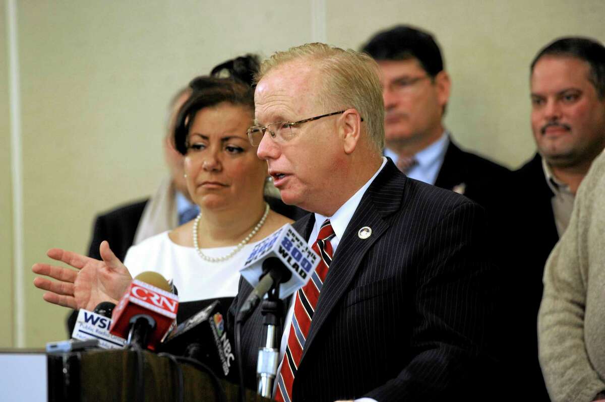 Danbury Mayor Mark Boughton, center, with his wife Phyllis at his side, announces his intention to run for governor during a news conference Wednesday, Jan. 8, 2014, in Danbury, Conn. The seven-term mayor said Wednesday he's seeking the Republican party's nomination this year because he believes Connecticut residents are not "getting their fair share of the American dream." (AP Photo/The News-Times, Carol Kaliff)