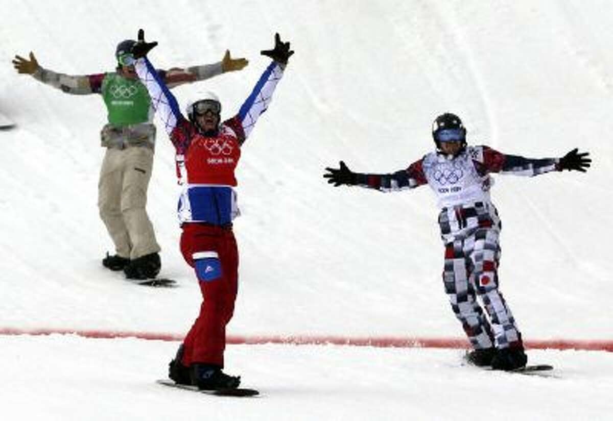 France's Pierre Vaultier, second left, celebrates taking the gold medal ahead of silver medalist Nikolai Olyunin of Russia, right, and bronze medalist Alex Deibold of the United States in the men's snowboard cross final at the Rosa Khutor Extreme Park, at the 2014 Winter Olympics, Tuesday, Feb. 18, 2014, in Krasnaya Polyana, Russia.