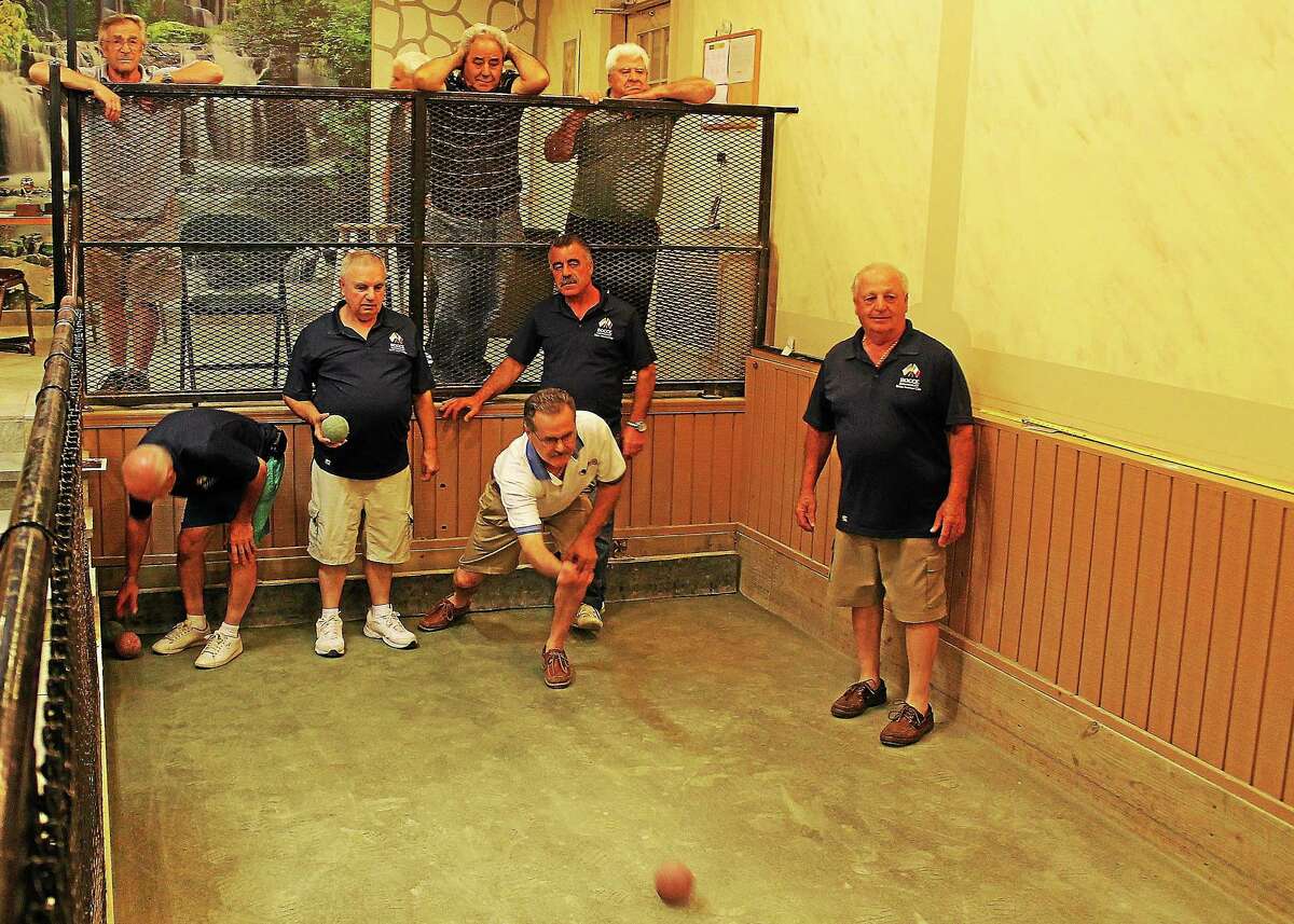 Ralph Viscuso of the Hamden bocce team (white shirt) visits the East Haven Italian American Club for an impromptu practice session last week.