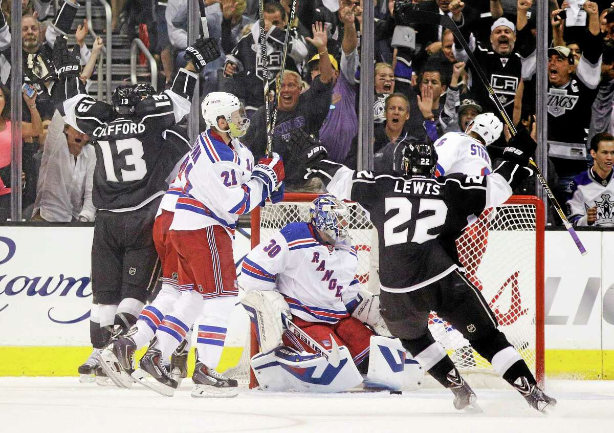 Los Angeles Kings left wing Kyle Clifford (13) and Trevor Lewis (22) celebrate a goal by Clifford during the first period of Game 1 in the NHL Stanley Cup Final hockey series against the New York Rangers on Wednesday in Los Angeles.