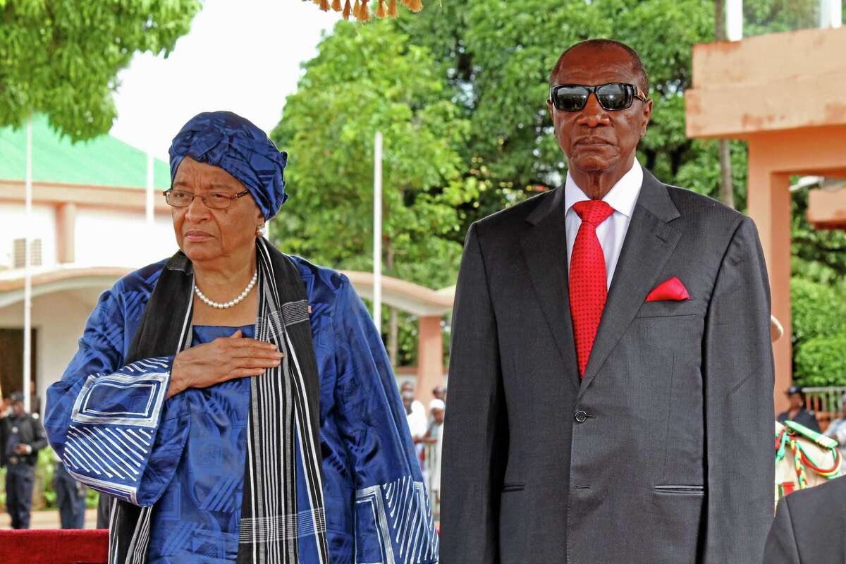 Liberia President Ellen Johnson Sirleaf, left, and Guinean President Alpha Conde, right, after meetings on the Ebola virus in the city of Conakry, Guinea, Friday, Aug. 1, 2014. An Ebola outbreak that has killed more than 700 people in West Africa is moving faster than the efforts to control the disease, the head of the World Health Organization warned as presidents from the affected countries met Friday in Guinea's capital. Dr. Margaret Chan, director-general of the World Health Organization, said the meeting in Conakry "must be a turning point" in the battle against Ebola, which is now sickening people in three African capitals for the first time in history. (AP Photo/ Youssouf Bah)