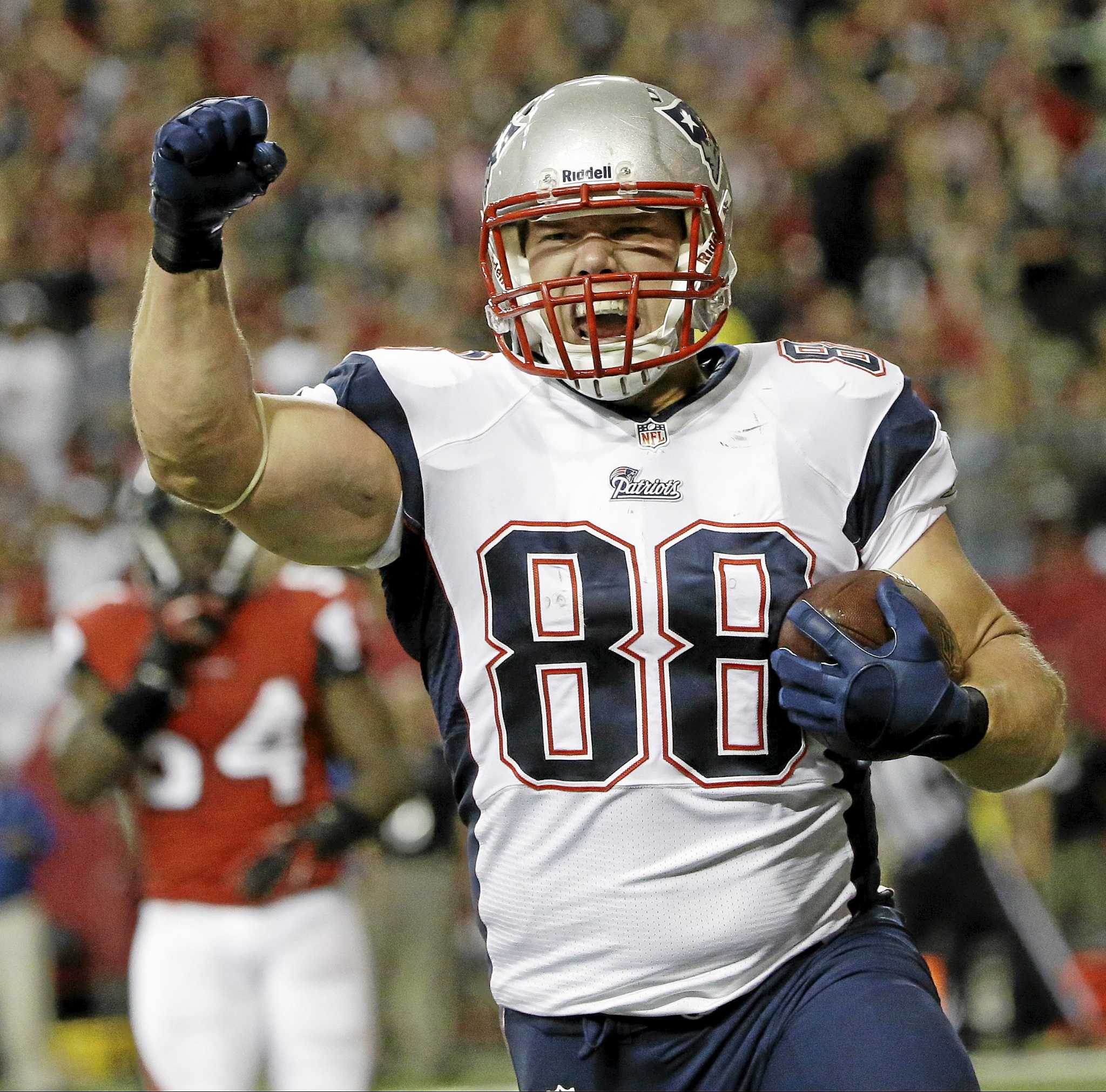 New England Patriots' Matthew Mulligan (88) celebrates his touchdown  against the Atlanta Falcons with Patriots quarterback Tom Brady (12) during  the first half at the Georgia Dome in Atlanta on September 29