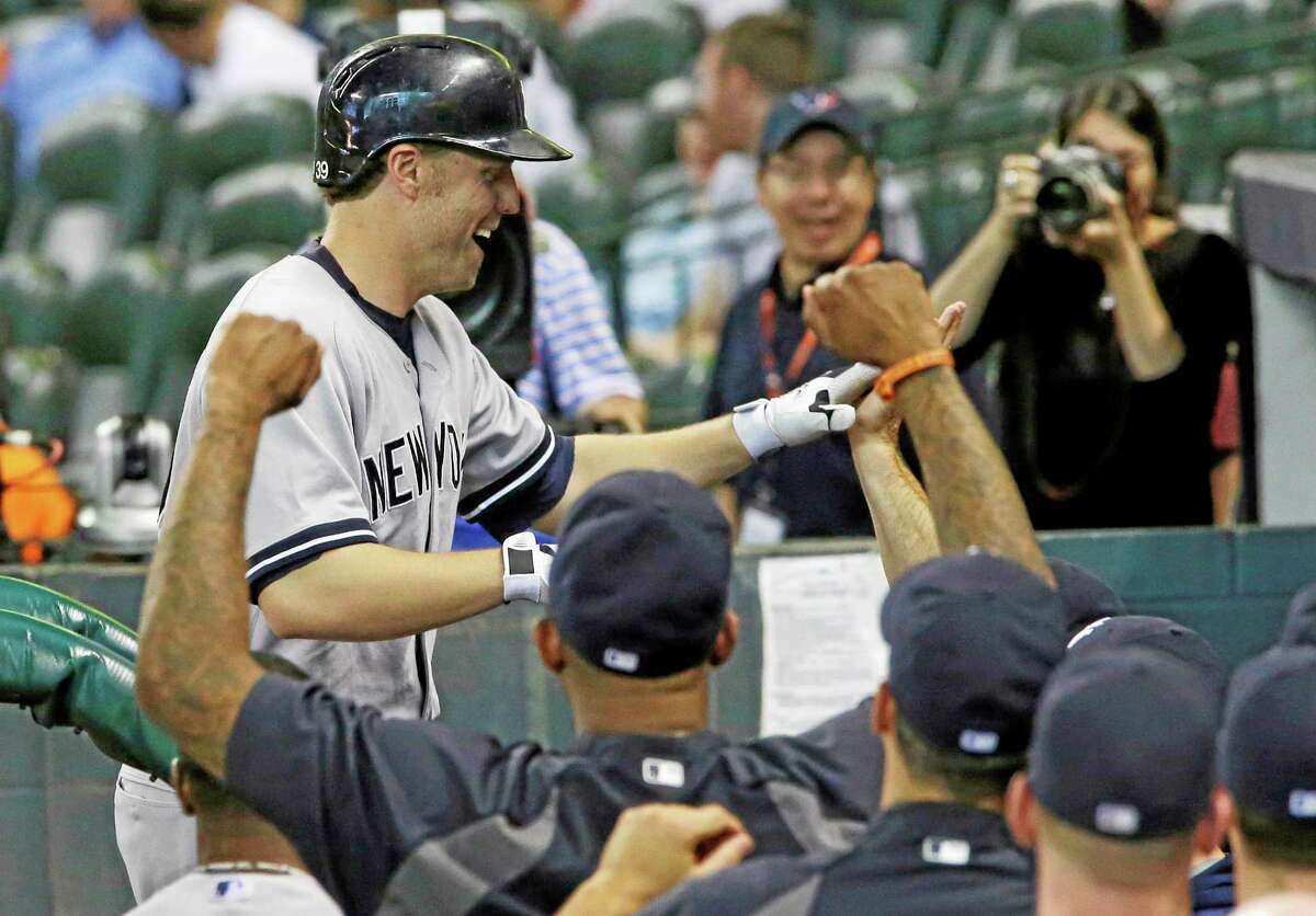 Mark Reynolds is greeted by teammates after his solo home run in the 14th inning against the Houston Astros Sunday.