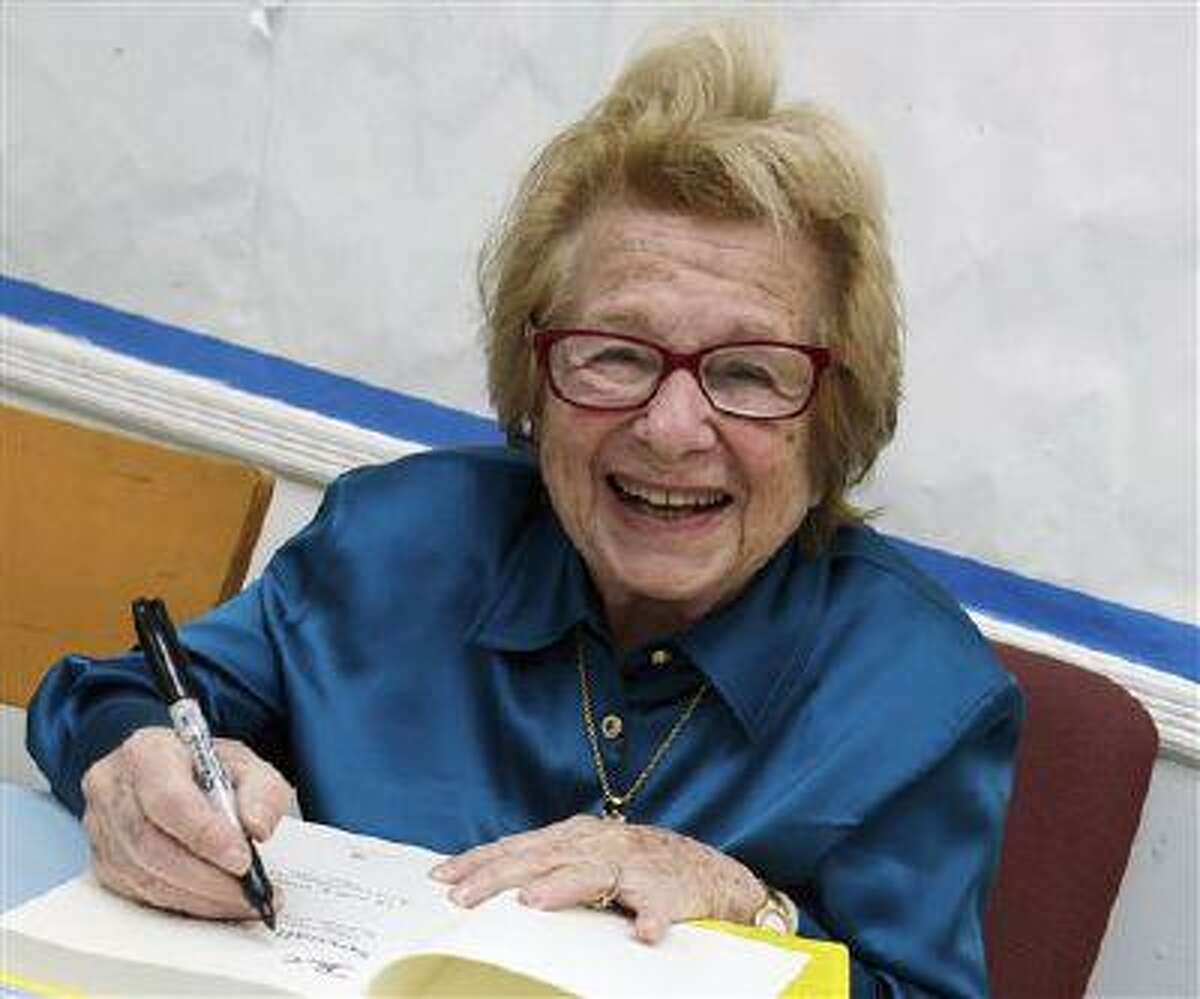 FILE - In this April 26, 2012 file photo, Dr. Ruth Westheimer signs a copy of her book in New York. The famed 85-year-old sex therapist says doctors often lack training in discussing sex with patients, but that they should. She says partners are often as concerned as patients themselves. She was commenting on detailed new guidelines released Monday, July 29, 2013, by the American Heart Association and the European Society of Cardiology. The groups say doctors need to bring up sex issues early and often after a heart attack, stroke or other heart problem. Sex is often possible and the groups offer advice on when and how to resume intimacy. (AP Photo/Richard Drew, File)