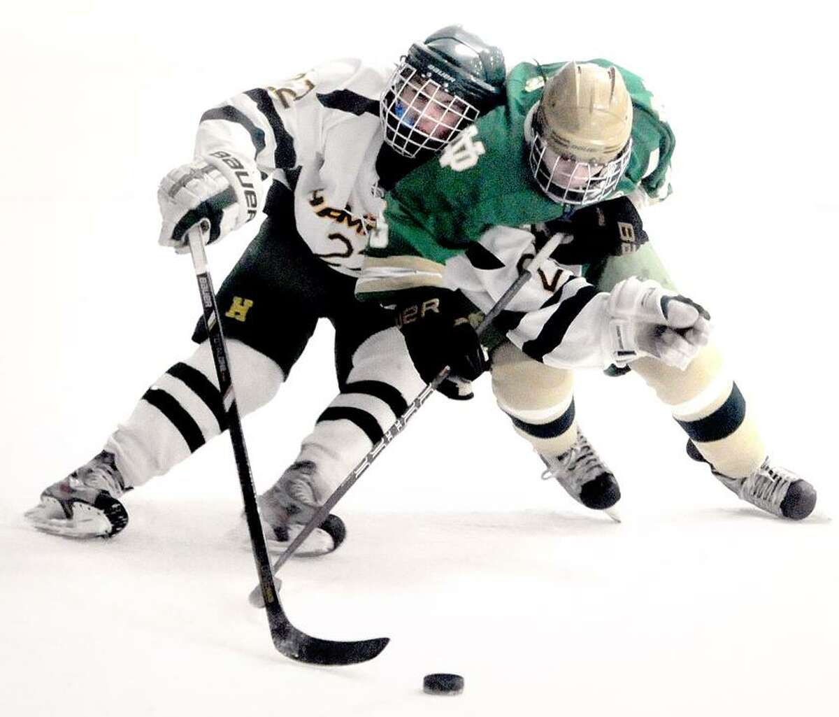 Michael DeMatteis (left) of Hamden and Cameron Hotchkiss (right) of Notre Dame of West Haven fight for the puck in the first period on 1/26/2013.Photo by Arnold Gold/New Haven Register