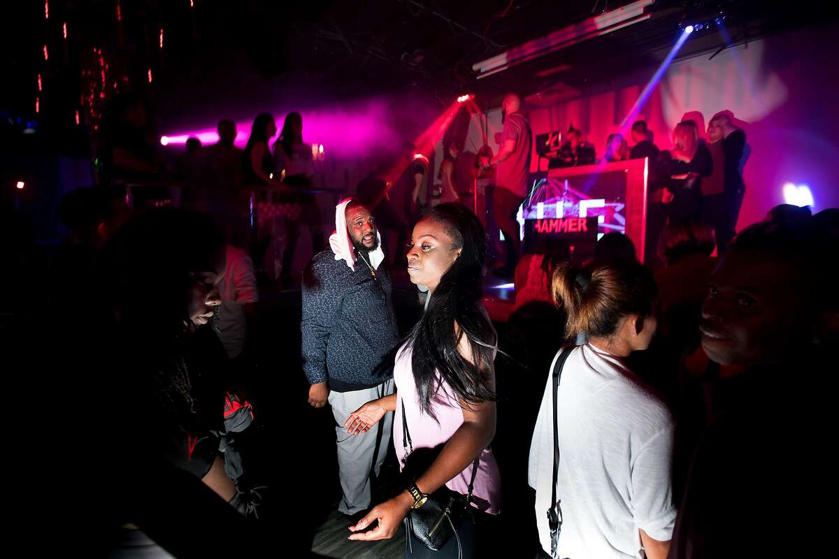 Allie Arnold dances at Hue Lounge and Nightclub in the early hours of Sunday, July 23, 2017, in San Francisco. The owner of the North Beach nightclub says that police and neighbors unfairly target the club.