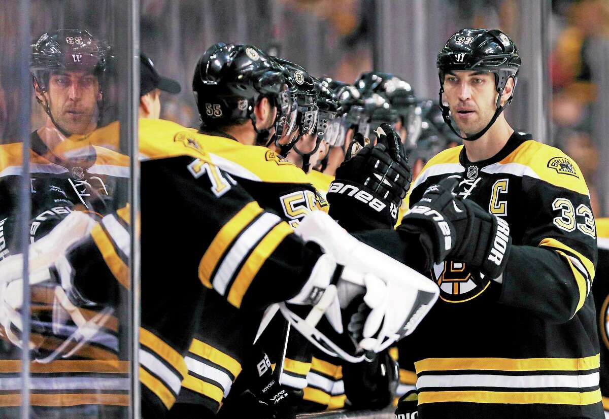 Bruins defenseman Zdeno Chara is congratulated by teammates after a goal against the Washington Capitals during the third period on Monday in Boston. Chara scored twice in the Bruins’ 3-2 overtime win.