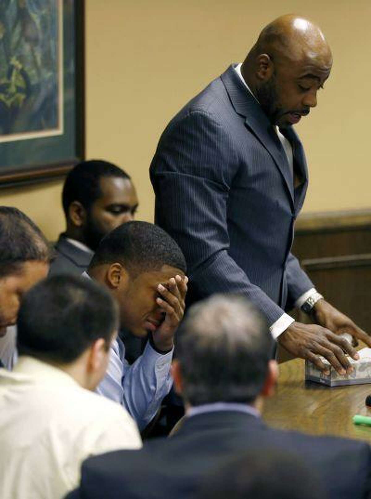 Ma'Lik Richmond covers his eyes and cries as his attorney Walter Madison, standing, asks the court for leniency after Richmond and co-defendant Trent Mays, lower left, were found delinquent on rape and other charges after their trial in juvenile court in Steubenville, Ohio, March 17. Mays and Richmond were accused of raping a 16-year-old West Virginia girl in August 2012.
