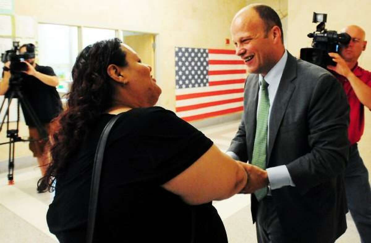 Garth Harries, newly appointed City of New Haven Superintendent of Schools, right, is congratulated by East Rock School PTO President and Citywide Parent Leadership Team member Daisy Y. Gonzales Thursday July 25, 2013 at the Fair Haven School in New Haven. Peter Hvizdak/New Haven Register