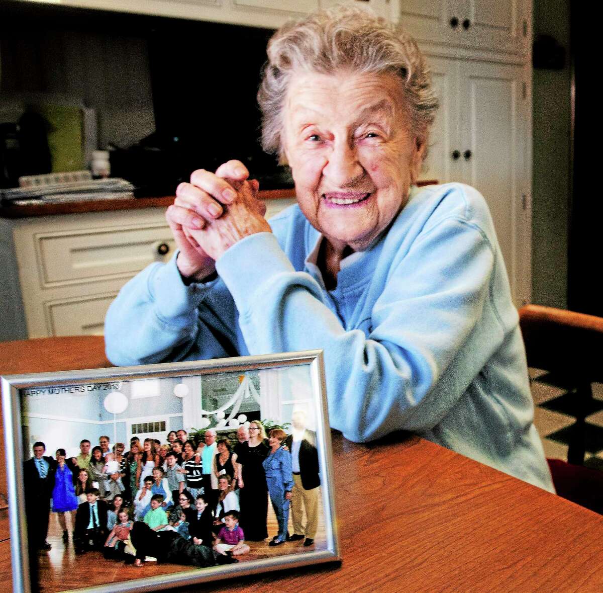 Louise Bonito, 100, of North Haven with a photo of her family.