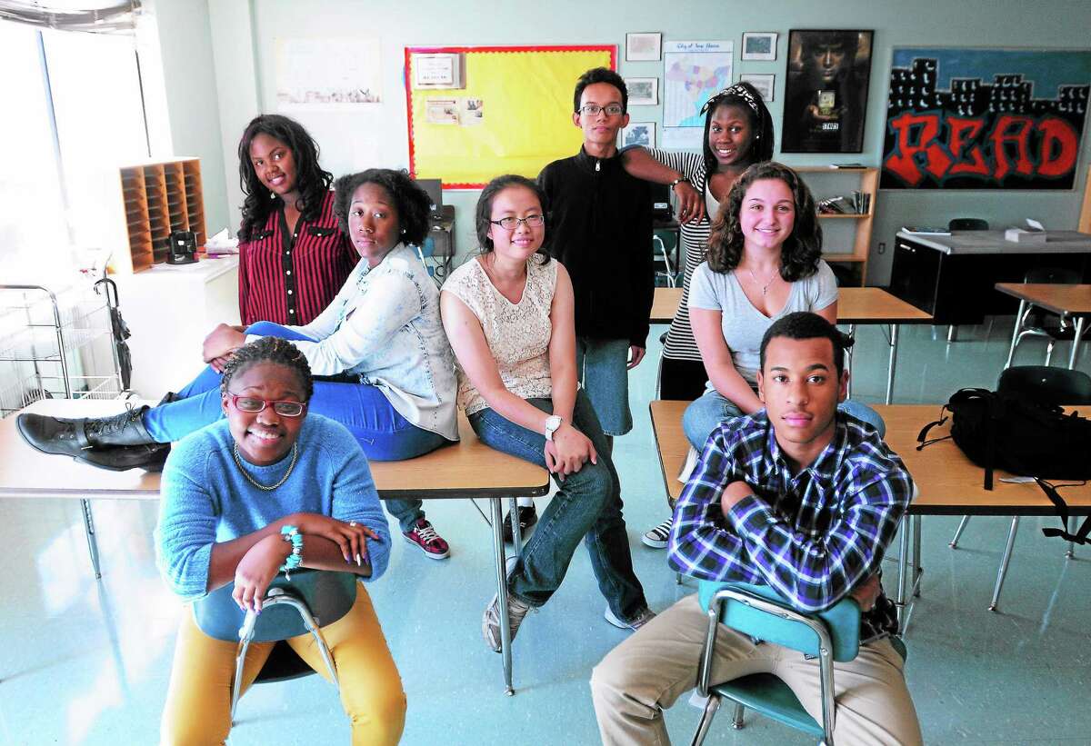 (Arnold Gold — New Haven Register) Clockwise from bottom left, journalism class members Shainah Andrews, 16, Asiayana McCain, 14, Erica Carr, 16, Amy Zheng, 16, Alif Albiruni, 16,Tawaka Henderson, 18, Marisa Misbach, 16, and Angel Guzman, 16, are photographed at the High School in the Community in New Haven on 9/19/2013.