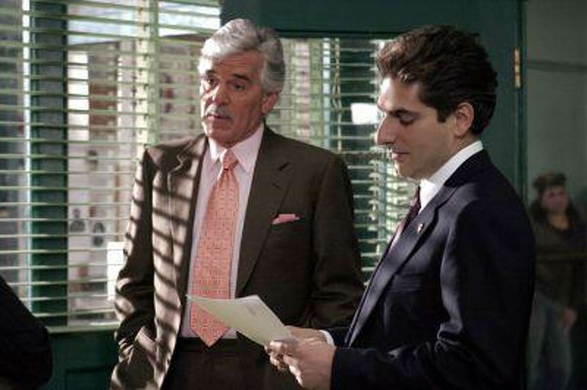 FILE - In this undated photo from NBC Universal, Dennis Farina, who plays New York Police Detective Joe Fontana, acts in a scene with Michael Imperioli in the role of Detective Nick Falco, in an episode from NBC's police drama,"Law & Order." Farina died suddenly on Monday, July 22, 2013, in Scottsdale, AZriz., after suffering a blood clot in his lung. He was 69. (AP Photo/ NBC Universal,Jessica Burstein)