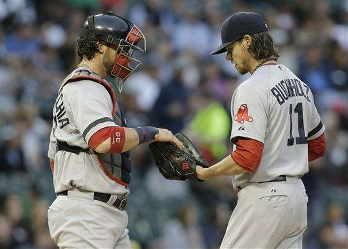 Boston Red Sox catcher Jarrod Saltalamacchia, left, talks with starter Clay Buchholz during the first inning of a baseball game against the Chicago White Sox in Chicago, Wednesday, May 22, 2013. (AP Photo/Nam Y. Huh)