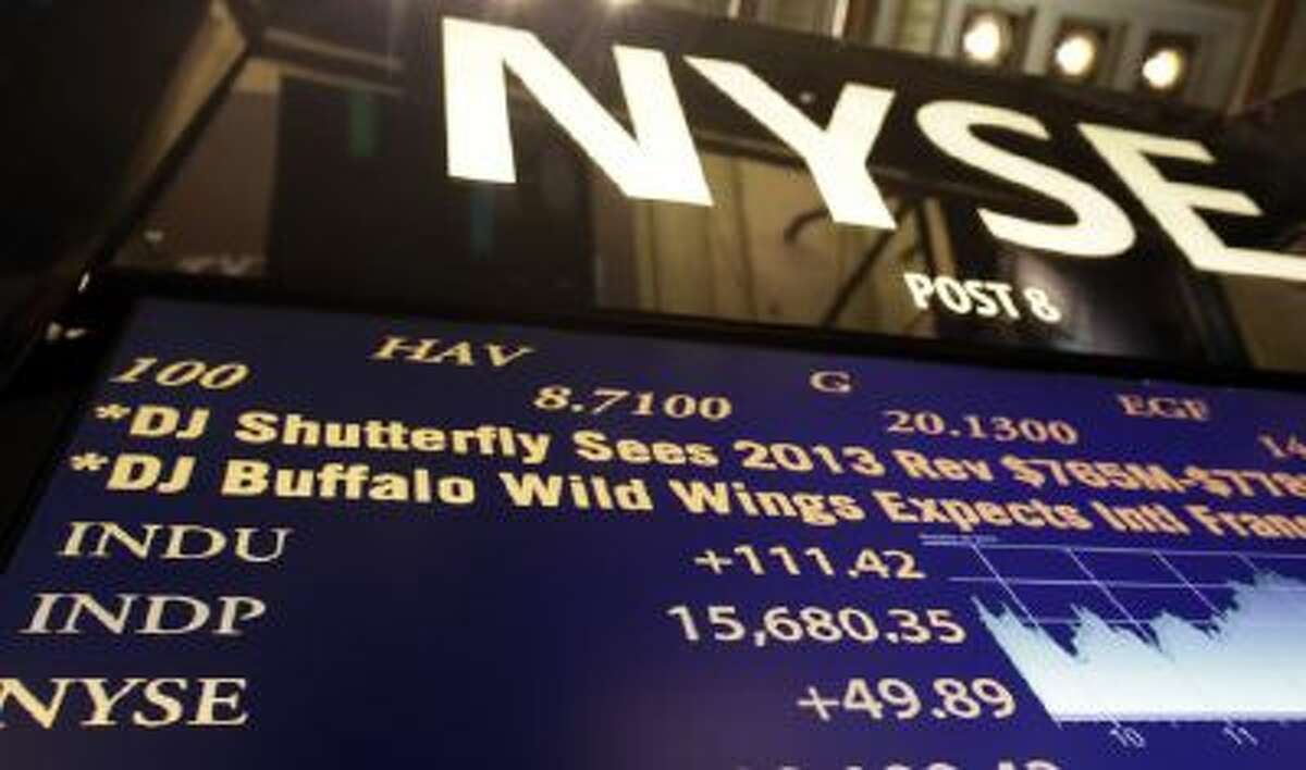 A board on the floor of the New York Stock Exchange shows the record closing number for the Dow Jones industrial average on Oct. 29.