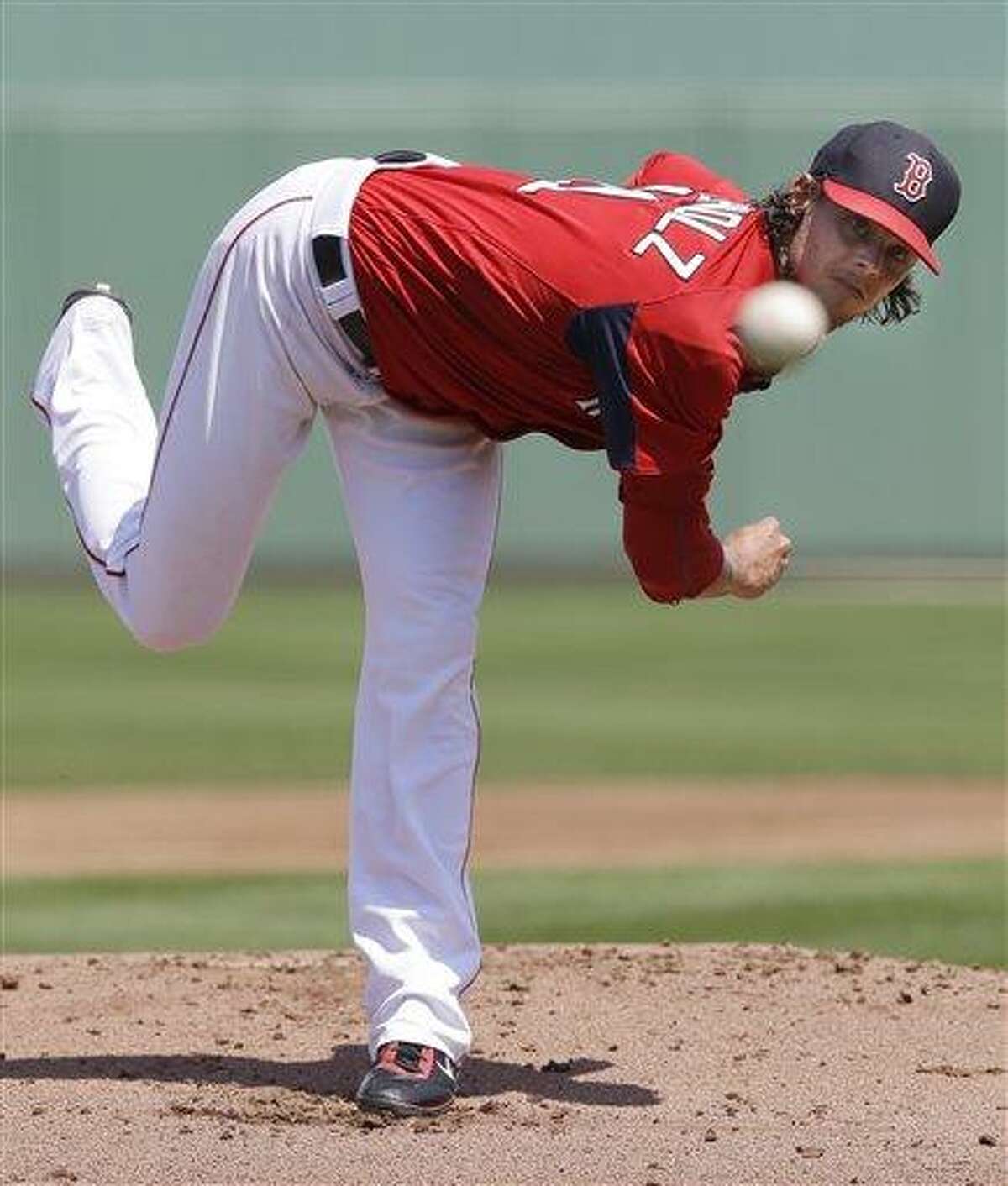 Boston Red Sox starting pitcher Clay Buchholz delivers to the Pittsburgh Pirates in the first inning of an exhibition spring training baseball game in Fort Myers, Fla., Saturday, March 23, 2013. (AP Photo/Elise Amendola)