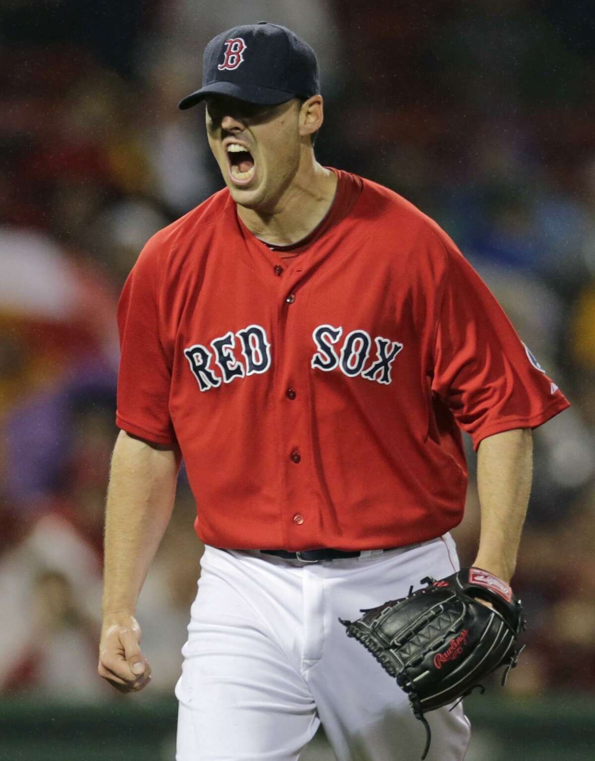Boston Red Sox starting pitcher John Lackey yells after striking out Cleveland Indians' Nick Swisher to end the top of the sixth inning of a baseball game at Fenway Park in Boston, Friday, May 24, 2013. (AP Photo/Charles Krupa)