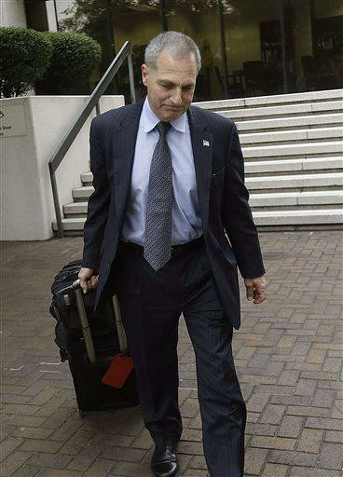 Former FBI Director Louis Freeh leaves Federal Court after meeting with U.S. District Judge Carl Barbier in New Orleans, Tuesday, July 2, 2013. Barbier appointed Freeh to investigate alleged misconduct by a lawyer who helped run BP's multibillion-dollar settlement fund. (AP Photo/Gerald Herbert)