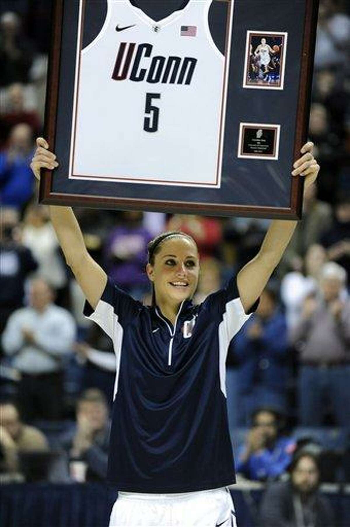 Caroline Doty holds up an award during Senior Night ceremonies before Connecticut's NCAA basketball game against Seton Hall in Storrs, Conn., Saturday, Feb. 23, 2013. (AP Photo/Fred Beckham)