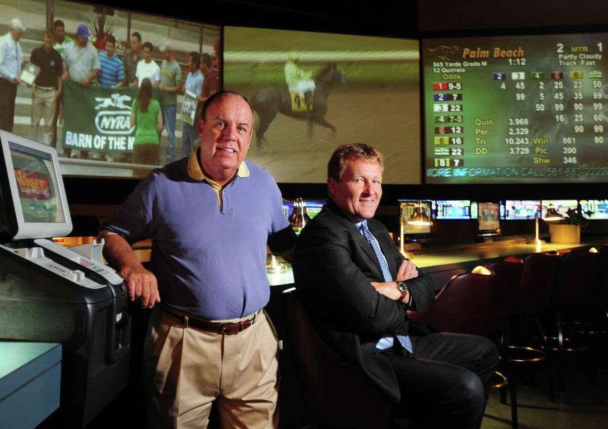 Peter Hvizdak Ñ RegisterState Representative Steve Dargan, D-West Haven, left, and Sportech managing director of sports venues Ted Taylor at Sports Haven in New Haven, Conn. Thursday July 11, 2013. Taylor's Sportech recently introduced a Connecticut-based online horserace betting operation for the first time and Dargan believes online wagering opportunities will continue in the state.