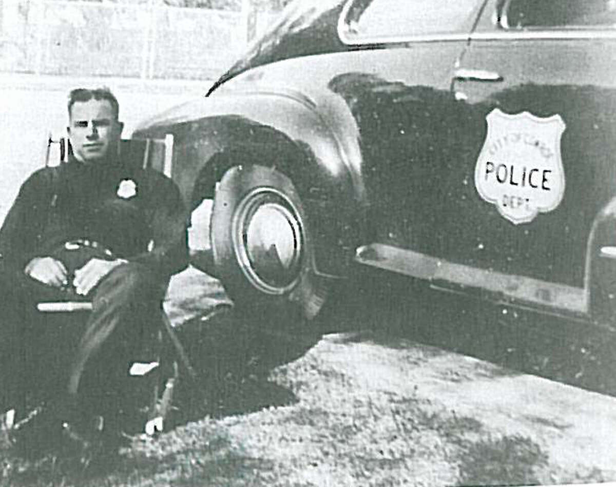 Conroe's first Chief of Police Eddie Stephan with Conroe's first police car. It was a 1947 Oldsmobile bought for about $1,000.