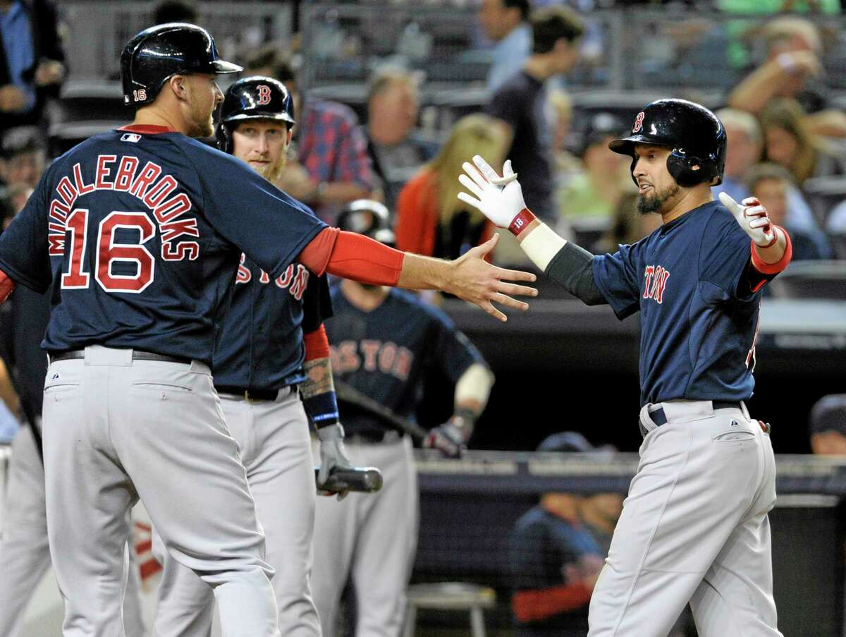 Boston Red Sox batter Shane Victorino, right, celebrates with Will Middlebrooks after Victorino hit a two-run home run during the eighth inning of a baseball game against the New York Yankees Friday,