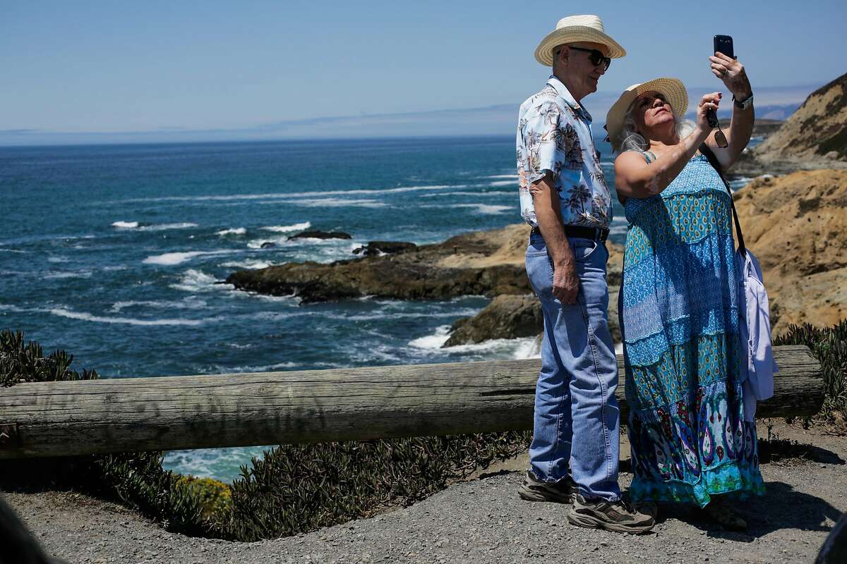 William Ferris and Martha Ferris, of Citrus Heights, California take a selfie at the ocean at Bodega Head in Bodega Bay, Calif., on Tuesday, July 25, 2017.