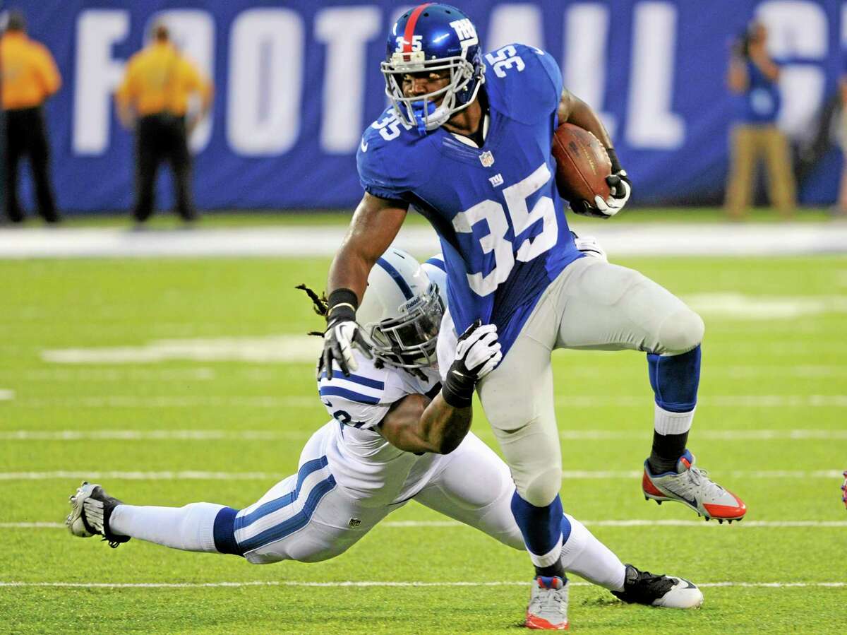 In this Aug. 18 file photo, New York Giants running back Andre Brown (35) breaks a tackle from the Indianapolis Colts’ Lawrence Sidbury during the first half of a preseason game in East Rutherford, N.J. With Brown about to come off injured reserve, the Giants have three players who could start this weekend against Oakland.