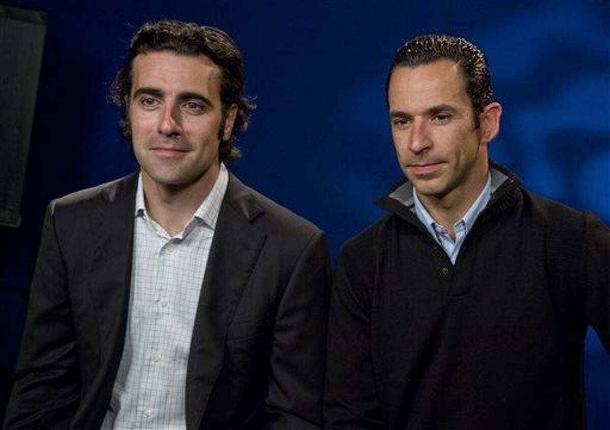 Scotland's Dario Franchitti, left, and Brazil's Helio Castroneves are interviewed, in New York, Monday May 20, 2013. They will try to become the first foreign-born four-time winners in Indianapolis 500 history at Sunday's race. (AP Photo/Richard Drew)