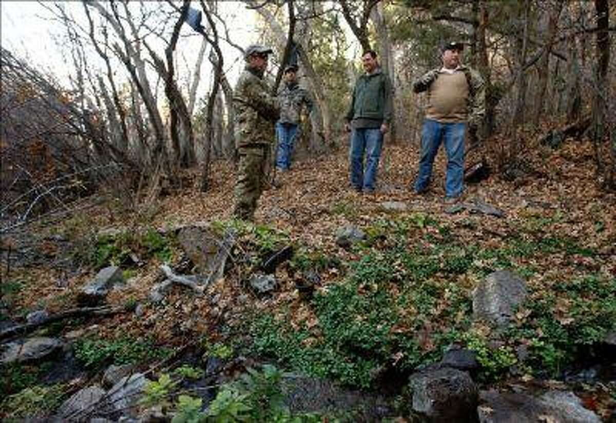 DEA and Narcotics Task Force agents, Rodney Holliday, Brian Lacy, Cliff Lark and Brian Bairett stand near the water source that fed a marijuana grove of over 4,200 plants last year in Iron County. Clothing, boots, backpacks and hygiene items littered the area. (Leah Hogsten, Salt Lake Tribune file photo)