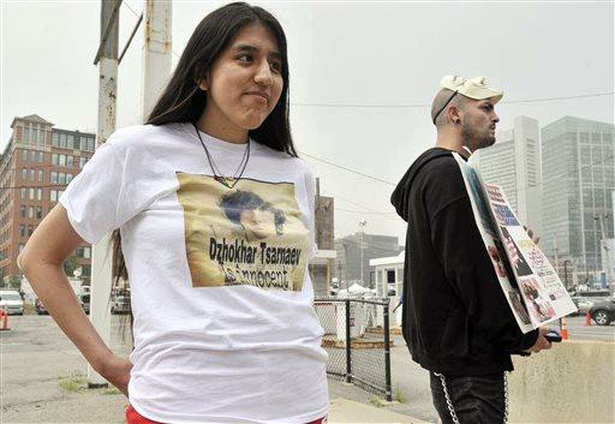 Jennifer Michio, left, from Mashantucket, Conn., and Duke La Touf, right, of Las Vegas, stand in support of Boston Marathon bombing suspect Dzhokhar Tsarnaev outside the federal courthouse prior to his arraignment Wednesday, July 10, 2013, in Boston. The April 15 attack killed three and wounded more than 260. The 19-year-old Tsarnaev has been charged with using a weapon of mass destruction, and could face the death penalty. (AP Photo/Josh Reynolds)