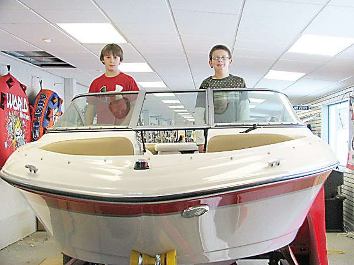 Photo Courtesy COOPER'S MARINA Jacob, left, and Adam Cooper, seen here at Cooper's Marina in Baldwinsville, earned their Young Boater Safety Certificates at the 2010 Central New York Boat Show.