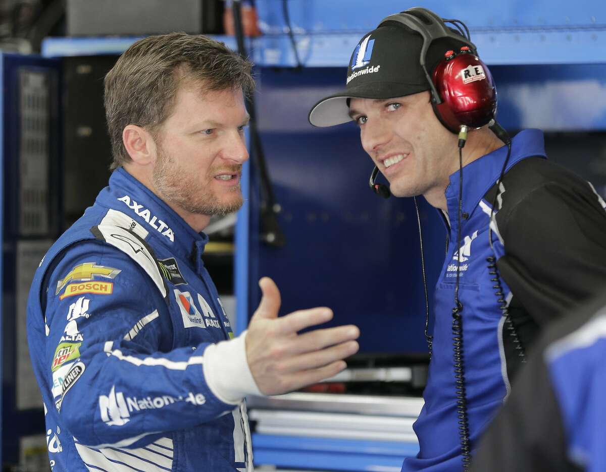 FILE - In this May 27, 2017, file photo, Dale Earnhardt Jr., left, talks with crew chief Greg Ives during practice for a NASCAR Cup series auto race at Charlotte Motor Speedway in Concord, N.C. Before Dale Eanrhardt Jr. calls it a career and starts calling races for NBC, he'd like to salvage a few positive memories from this season.And he'd like fans to quit ripping his embattled crew chief. (AP Photo/Chuck Burton, File)