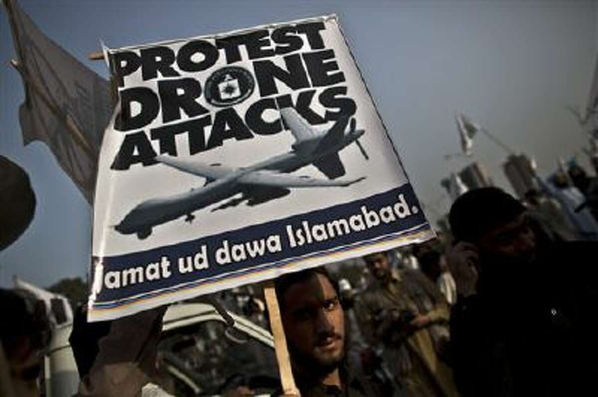 A supporter of the Pakistani religious party Jamaat-u-Dawa holds up a banner during a rally to condemn U.S. drone attacks in Pakistan.