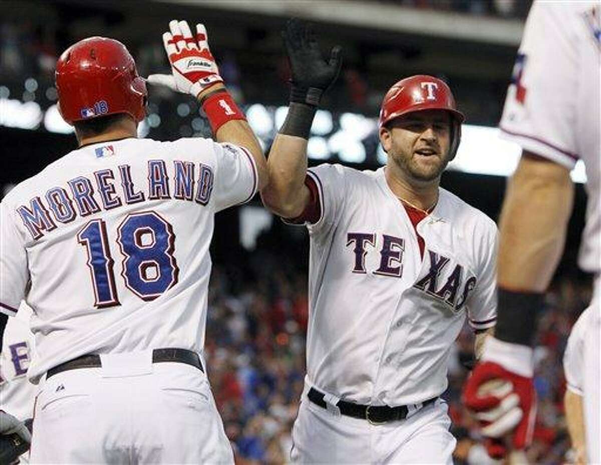 Texas Rangers' Mike Napoli, right, celebrates his home run with Mitch Moreland (18) during the third inning of the second baseball game of a doubleheader against the Los Angeles Angels, Sunday, Sept. 30, 2012, in Arlington, Texas. (AP Photo/LM Otero)