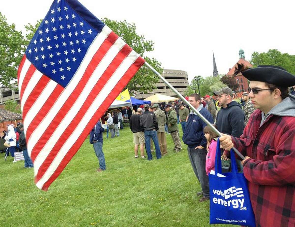 PHOTO BY JOHN HAEGER @ ONEIDAPHOTO ON TWITTER/ONEIDA DAILY DISPATCHHunter VanDresar of Holland Patent holds an American Flag as he and other listen to speeches against the NY Safe Act during a rally on the lawn at Fort Stanwix in Rome on Sunday, May 19, 2013. The event was organized by the New York Revolution Oneida County 2nd Amendment Community.