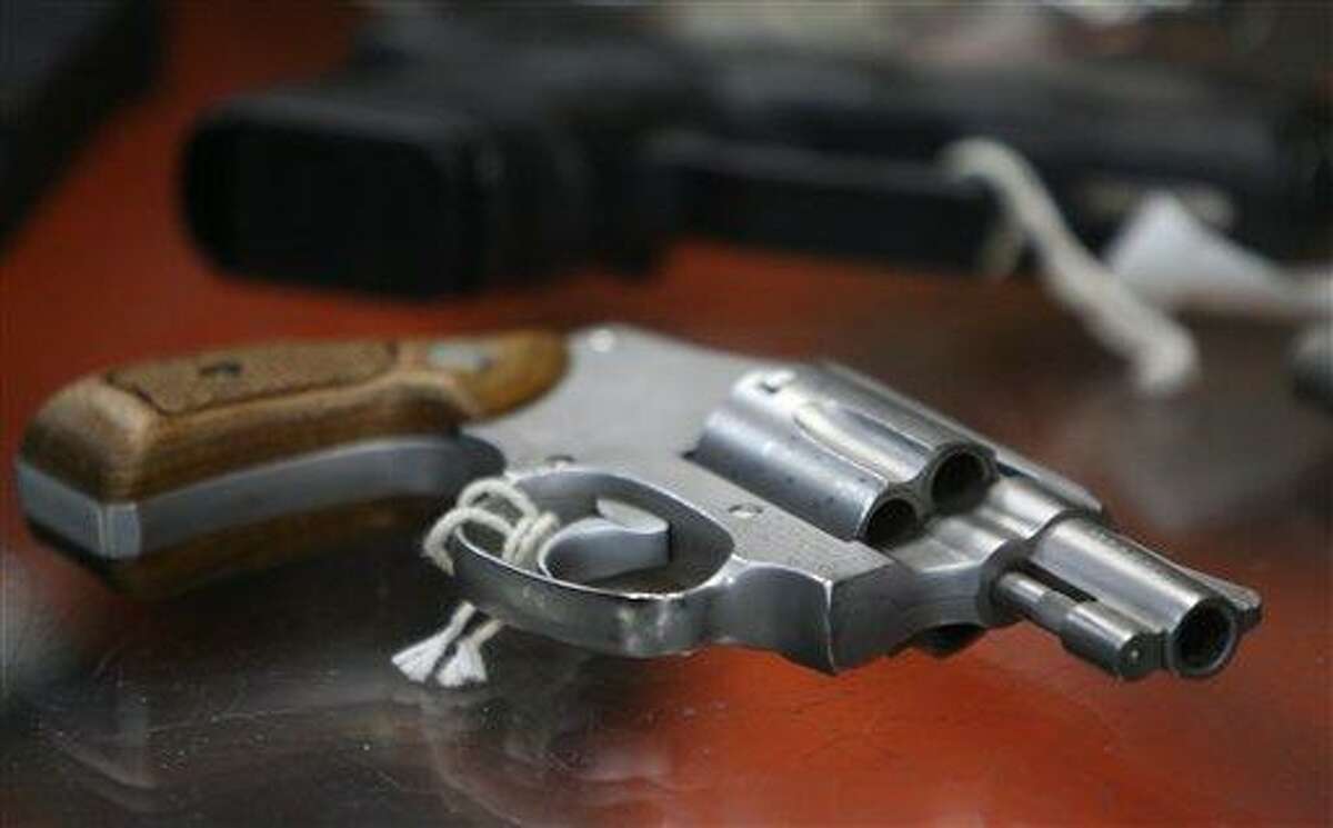 In this June 26, 2008 file photo, a chrome plated revolver rests on top of a glass display case at a gun shop in New York. (AP Photo/Seth Wenig, File)
