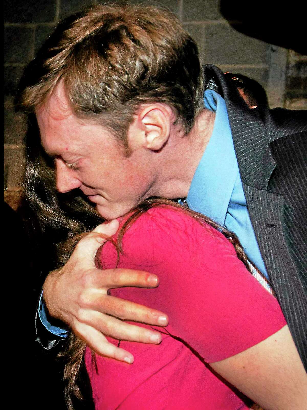 (Melanie Stengel — New Haven Register) New Haven mayoral candidate, Justin Elicker, hugs his wife, Natalie, after concedeing to Toni Harp 6/5.