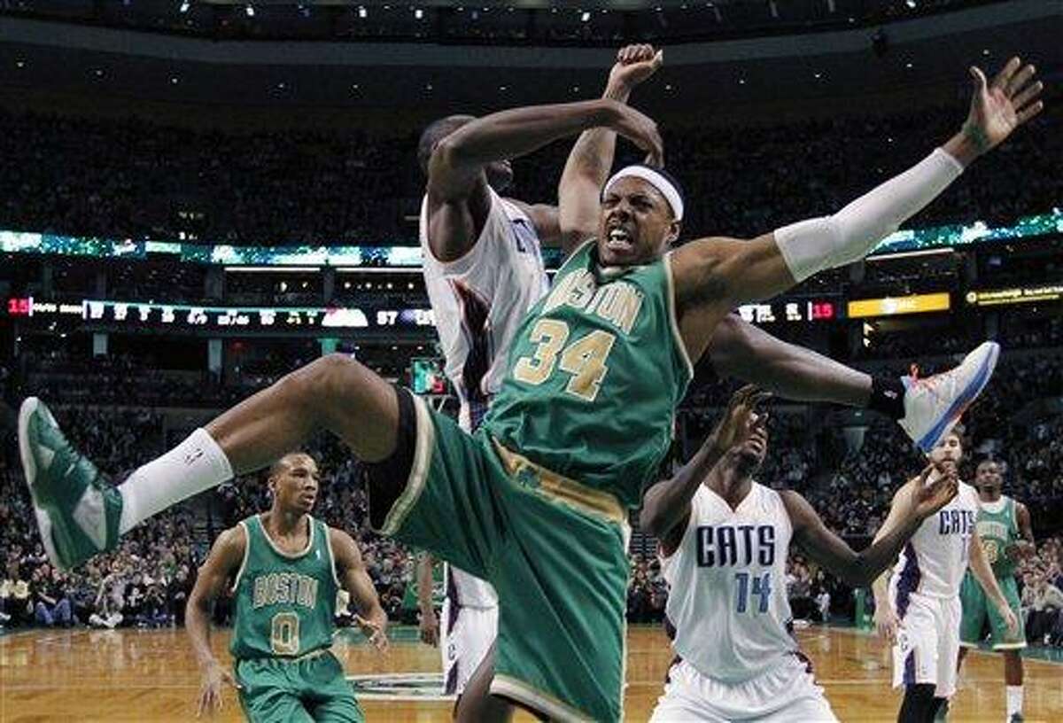 Boston Celtics' Paul Pierce (34) comes down after having his shot blocked by Charlotte Bobcats' Bismack Biyombo, behind, in the second half of an NBA basketball game in Boston, Saturday, March 16, 2013. The Celtics won 105-88. (AP Photo/Michael Dwyer)