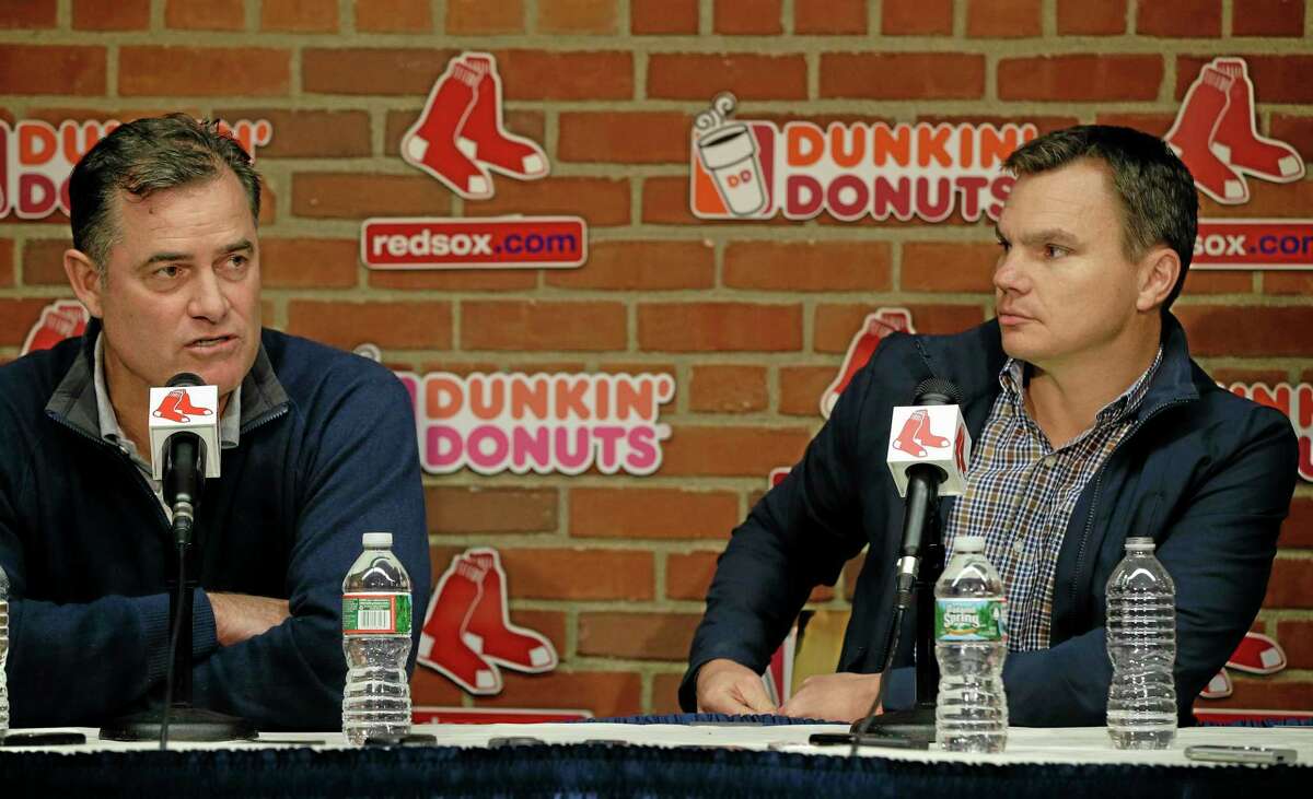 Boston Red Sox Executive Vice President/General Manager Ben Cherington, right, looks on as Sox Manager John Farrell responds to a reporter’s question during a media availability at Fenway Park on Monday.