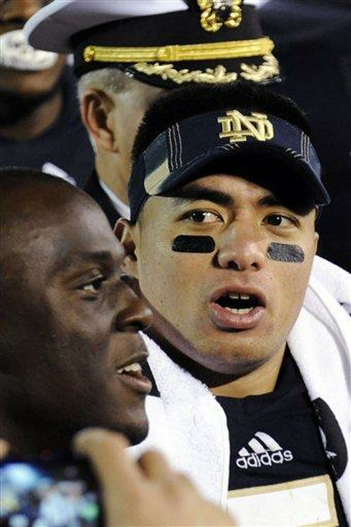 In this Nov. 17, 2012, photo, Notre Dame linebacker Manti Te'o sings the alma mater following their NCAA college football game against Stanford in South Bend, Ind. A story that Te'o's girlfriend had died of leukemia _ a loss he said inspired him to help lead the Irish to the BCS championship game _ was dismissed by the university Wednesday, Jan. 16, 2013, as a hoax perpetrated against the linebacker. (AP Photo/Joe Raymond)