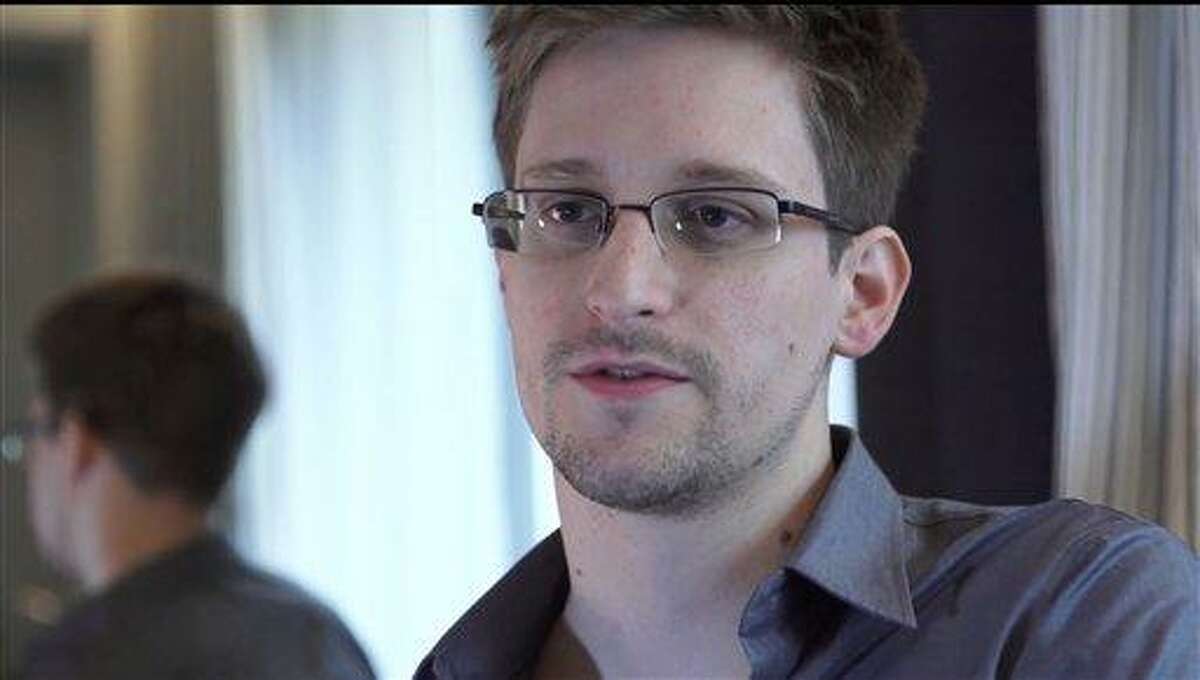 This photo provided by The Guardian Newspaper in London shows Edward Snowden, who worked as a contract employee at the National Security Agency, on Sunday, June 9, 2013, in Hong Kong. NSA leaker Edward Snowden claims the spy agency gathers all communications into and out of the U.S. for analysis, despite government claims that it only targets foreign traffic. (AP Photo/The Guardian, Glenn Greenwald and Laura Poitras)