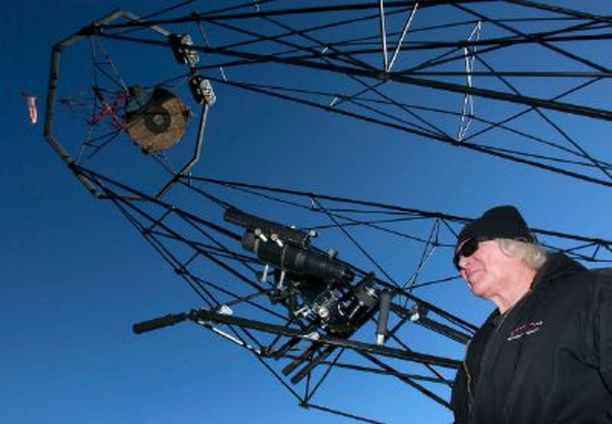 Mike Clements with his homemade 70-inch telescope in Herriman, Utah, Sunday, October 27, 2013. The 70-inch mirror and 35 foot length make it one of the biggest telescopes created by an amateur astronomer.