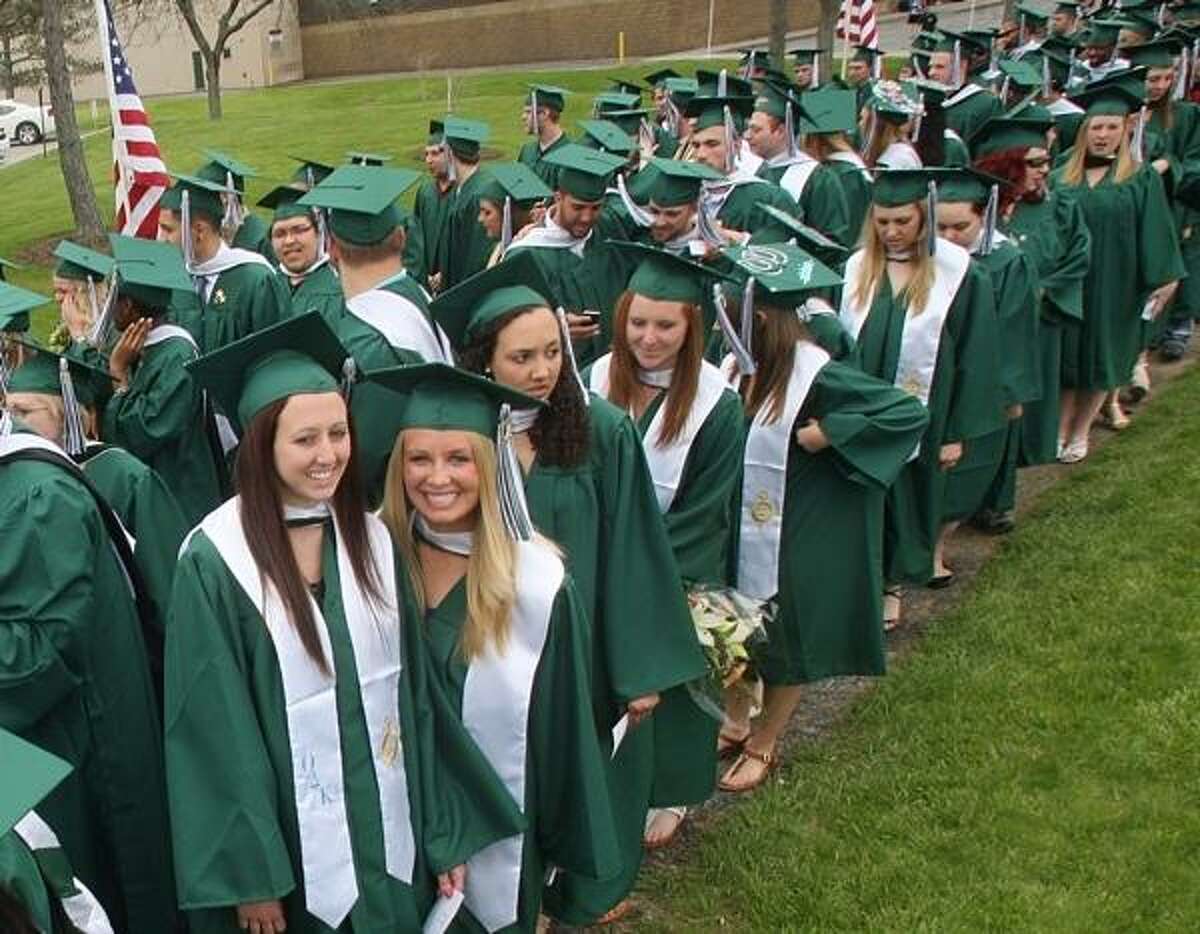 PHOTO BY JOHN HAEGER @ ONEIDAPHOTO ON TWITTER/ONEIDA DAILY DISPATCH members of the class of 2013 make their way to the start of the 102nd commencement ceremony at Morrisville State College on Saturday, May 18, 2013.