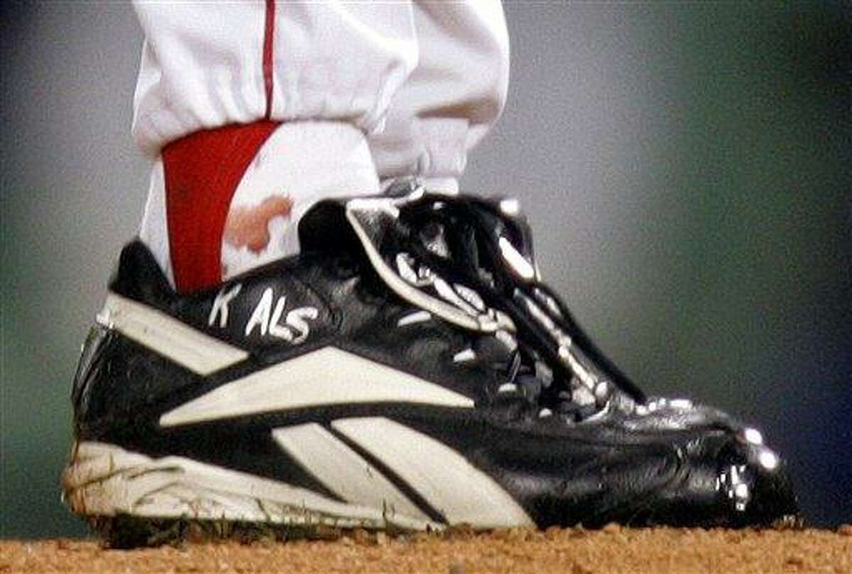 FILE - In this Oct. 24, 2004, file photo, blood appears around the right ankle of Boston Red Sox pitcher Curt Schilling during the sixth inning of Game 2 of baseball's World Series against the St. Louis Cardinals in Boston. Schilling, whose video game company underwent a spectacular collapse into bankruptcy last year, is selling the blood-stained sock he wore during that game. (AP Photo/Winslow Townson, File)