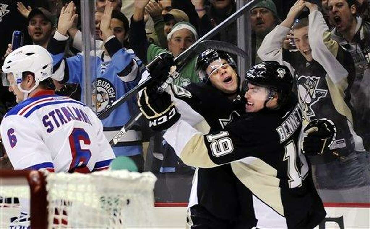 Pittsburgh Penguins' Beau Bennett (19) is congratulated by Tyler Kennedy after scoring on New York Rangers goaltender Henrik Lundqvist, not shown, as Anton Stralman (6) skates by in the first period of their NHL hockey game, Saturday, March 16, 2013, in Pittsburgh. The Penguins won 3-0. (AP Photo/Pittsburgh Post-Gazette, Matt Freed)