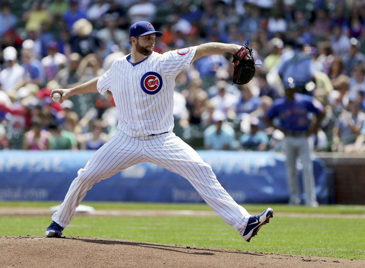 Chicago Cubs starter Scott Feldman pitches to the New York Mets in the first inning of a baseball game in Chicago on Saturday, May 18, 2013. (AP Photo/Charles Cherney)
